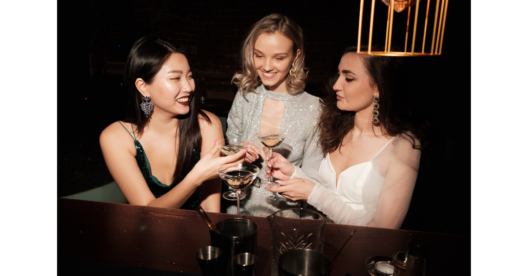 Girls at the bar drinking prosecco wine. 