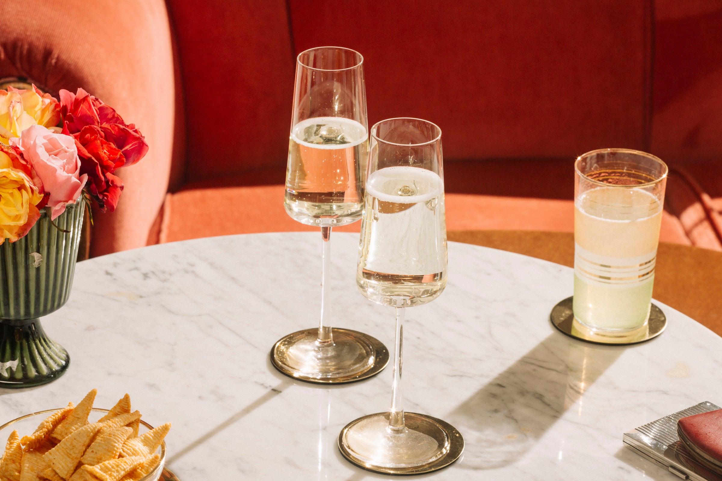 Bottle of Nouvie Sparkling Wine placed on an outdoor table, surrounded by soft natural light and casual table decor.